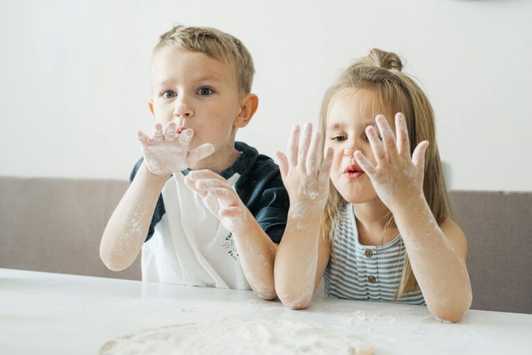 Children playing with flour at home, showcasing fun and creativity in the kitchen.